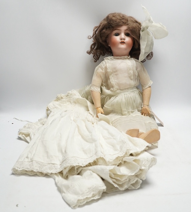 An Alt. Beck & Gottschalk bisque doll and three baby dresses, 61cm high. Condition - no visible hairline cracks to head or serious damage to body, dresses and dolls dress in good order, may need washing